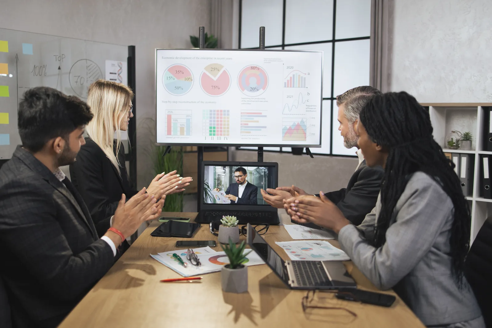 Small marketing team on a video call walking a client through a monthly results report