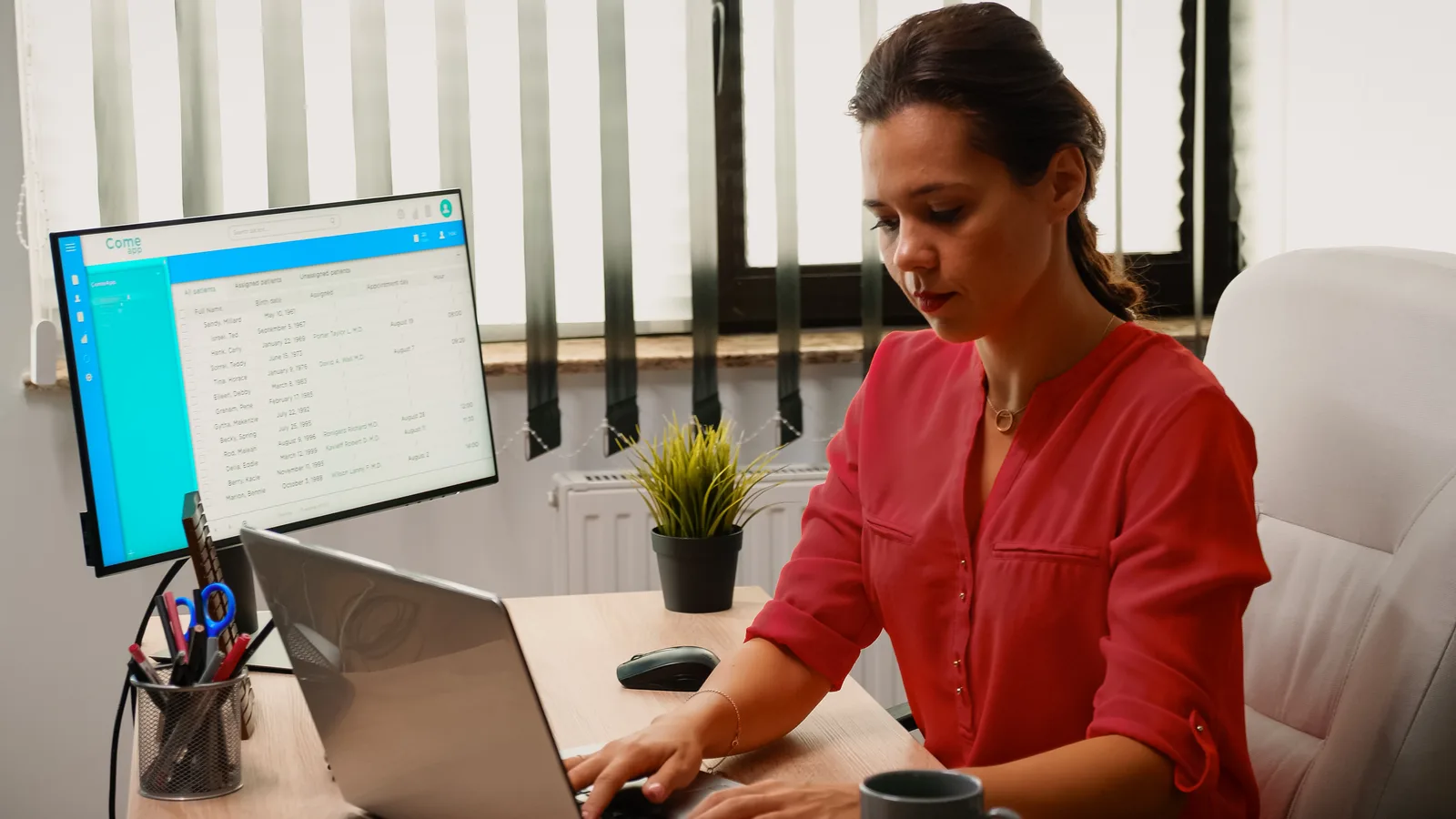 A woman at her desk works through a settings dashboard on her monitor, adding the DNS records for a sending domain