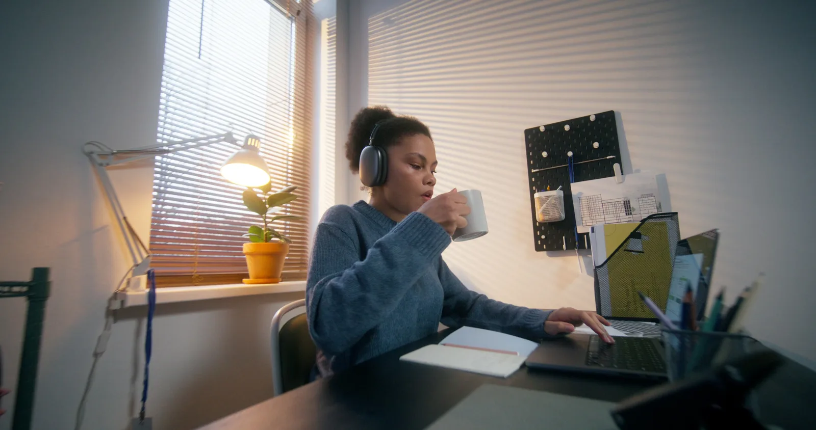 Remote specialist in a headset screen-sharing with an office manager while following a written checklist