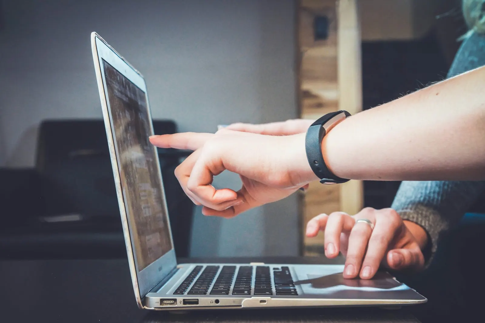 Hands typing on a laptop keyboard